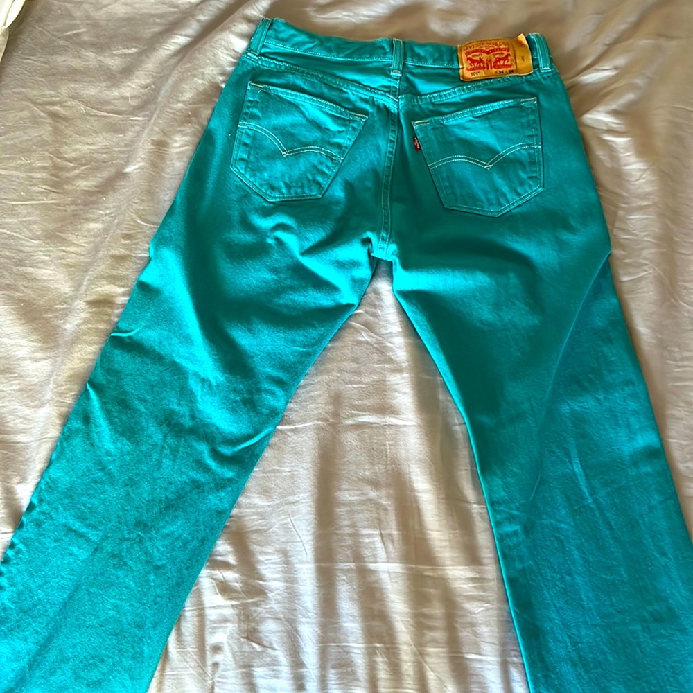 Teal denim with white buttons and stitching